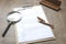Closeup of a resume application,clipboard,pen, magnifier on wooden table,working process-hiring new people.Concept of hiring new e