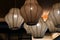Closeup of retro pendant lights with Chinese traditional lampshades hanging under ceiling. Stained glass surface of lamps