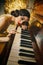 Closeup retro portrait woman musician plays piano melody touches keys her hand