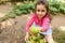 Closeup of ripe organic fresh harvested pear in the hand of blurred lovely child girl, in eco field