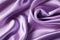 Closeup of rippled purple satin fabric cloth texture background