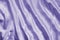 Closeup of rippled violet silk fabric lines