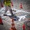 Closeup of road worker preparing a white pictogram at a street with orange cones for safety & x28;square& x29;