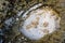 Closeup of a rock formation with a sand surface