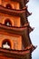 Closeup of roofline architectural details and little white Buddhas of the Tran Quoc Pagoda, Hanoi, Vietnam