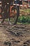 closeup on root passage of a secured race track ridden by mountainbike race driver with orange fork in background