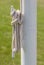 Closeup rope tied on the white iron pole.