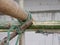 Closeup of rope tightly tied with bamboo scaffolds that are installed high above the ground around the constructing building