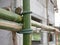 Closeup of rope tightly tied with bamboo scaffolds that are installed high above the ground around the constructing building