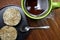 Closeup round shape of fried rice cakes with glass of water in black plate on natural light