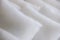 Closeup of rows of white fluffy pillows