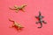Closeup of rubber lizard toys on a red surface