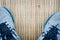 Closeup running shoes on traditional mat, copyspace on the middl