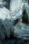 Closeup of rushing water and icicles at a cascade of Saale river in Thuringia, Germany