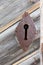 Closeup of a rustic empty lock on a wooden door