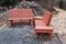 Closeup of rustic wooden benches nestled in the foliage of a roadside