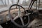 Closeup of a rusty steering wheel of an old vintage car during the rain