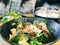 Closeup of a salad with greens and lime served in a bowl