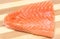 Closeup of salmon steak on wooden background