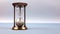 Closeup of a sand clock in the middle of the frame space on the right side. Closeup of a glass sand clock on white with