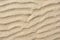 closeup of sand pattern of a beach in the summer