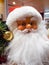 Closeup of Santa Claus Doll. Long Beard. Glasses. Golden Decorative Ball