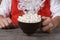 Closeup of Santa Claus holding a mug of hot fresh hot cocoa with marshmallows.