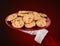 Closeup of Santa Claus holding a plate of cookies in the palm of his outstretched hand