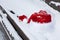 Closeup Santa Claus red hat on bench with snow