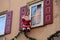 Closeup of a Santa decor hanging on a rope by a window