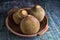 Closeup of sapote fruits in a wooden bowl