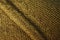 Closeup scene of seam on brown sweater in wardrobe