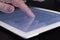 Closeup scrolling finger touching tablet