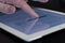 Closeup scrolling finger touching tablet