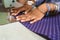 Closeup of a seamstress stitching cloth with her sewing machine