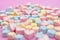 Closeup with selective focus colorful fluffy marshmallows on pink background