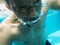 Closeup of senior black man underwater at swimming pool