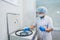 Closeup of a senior female chemist setting up some sample blood tubes inside a centrifuge for some test in a lab.