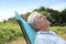 Closeup of senior man relaxing in long chair