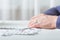 Closeup senior woman hands with pills and coins  on table at home. An elderly pensioner counts money