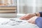 Closeup senior woman hands with pills and coins  on table at home. An elderly pensioner counts money