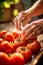 Closeup of senior woman hands washing ripe juicy homegrown tomatoes. Water splashes sunlight. Local produce farming concept