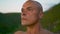 Closeup serene man meditating making namaste gesture. Athlete training mountains