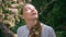 Closeup serene woman face under sunlight at forest greenery. Gentle girl nature