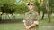 Closeup of serious male guard in military camouflage cap