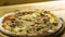 Closeup of serving freshly baked Italian pizza on wooden cutting board