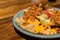 Closeup of a serving of tasty nachos on a wooden table