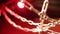 Closeup of a set of interlaced chains on a bright red background.