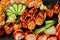 Closeup set of rolls, nigiri sushi and gunkan maki with salmon on black background