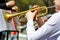 A closeup of several trumpeters playing in a brass band